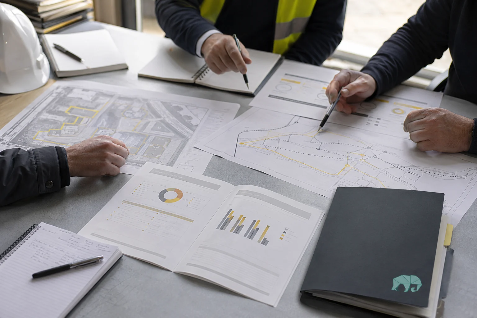 Construction team reviewing route maps and a practical post-pilot findings report.